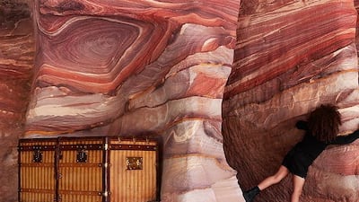 Children play on the pink rocks of Petra in the new campaign.