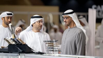 President Sheikh Mohamed speaks with two exhibitors during his tour of Adihex on Monday. Mohamed Al Hammadi / UAE Presidential Court