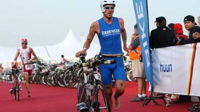 Competitors in 2012's Abu Dhabi International Triathlon transition from the swim portion to the bicycle segment. At 200 kilometres for the long course it is some 23 kilometres more than a standard triathlon and is what sets the Abu Dhabi event apart.