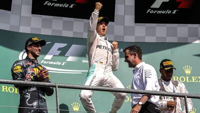 Nico Rosberg, centre, jumps atop the podium after winning the Belgian Grand Prix. Srdjan Suki / EPA