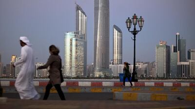 Abu Dhabi skyline lights up in a setting sun. Silvia Razgova / The National