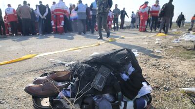 Belongings of passengers are brought from the site by search and rescue team members . Getty Images