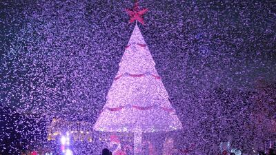 People gather under a Christmas Tree, marking the beginning of Christmas season in Zgharta city, north Lebanon. Omar Ibrahim / Reuters