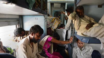 Indian passengers sleep on board the Kalka Mail train