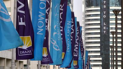 Emaar property flags dot a bridge in the Dubai Marina. Amy Leang / The National