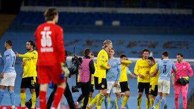 Borussia Dortmund's Erling Braut Haaland with Manchester City's Phil Foden after the match. Reuters
