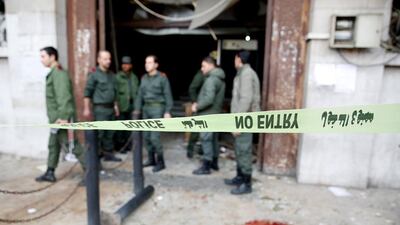 Syrian soldiers stand at a courthouse in the centre of Damascus following a suicide bombing there on March 15, 2017. Youssef Badawi / EPA