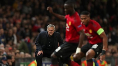 Manchester United manager Jose Mourinho looks on while Manchester United's Eric Bailly and Antonio Valencia challenge for the ball. Reuters