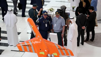 Visitors look at the unmanned vehicle at the Emirates Advanced Research & Technology Holding stand on the first day of the UMEX held at ADNEC in Abu Dhabi. Pawan Singh / The National