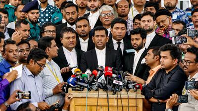 Mohammad Tajul Islam, chief prosecutor of Bangladesh's International Crimes Tribunal, centre, speaks to the media after 13 former senior government officials were arrested over accusations they 'enabled massacres' during an uprising in August. AFP