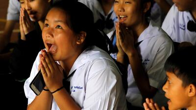 Classmates react after a teacher announced that four of the trapped boys had been rescued. Reuters