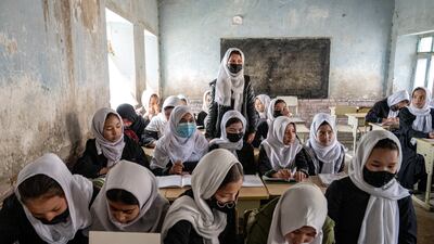 Afghan school girls attend their classroom on the first day of the new school year, in Kabul, on Saturday, March 25. AP