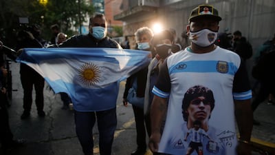 Fans gather outside Clinica Olivos where Diego Maradona underwent surgery in Buenos Aires. AP Photo