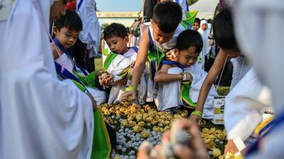 Malaysian Muslim children from the Little Caliphs kindergarten collect mock stones made from papier mache before performing the ritual of stoning the devil during an educational simulation of the pilgrimage in Shah Alam, outside Kuala Lumpur.