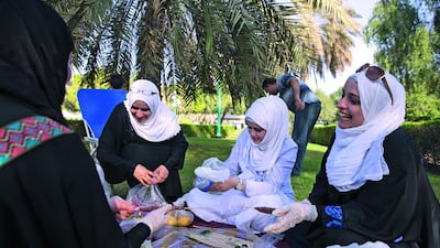 A family enjoying an Abu Dhabi park. Green spaces improve the quality of life in many ways. Silvia Razgova / The National