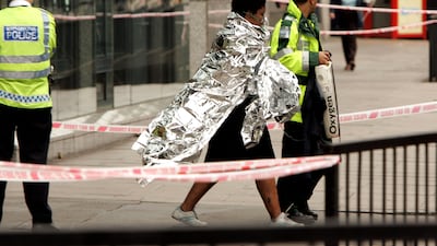 Emergency services help an evacuated passenger at Edgware Road station