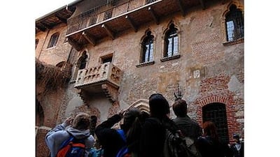 Tourists take pictures of the balcony at Juliet's house in Verona, northern Italy.