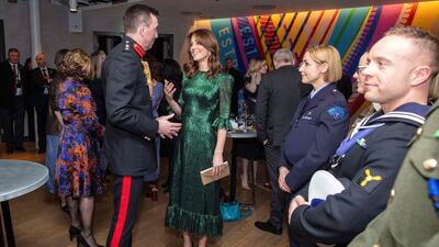 The duchess accessorised with Manolo Blahnik heels, a gold clutch and H&M earrings. AFP