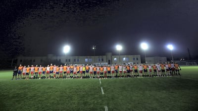 RAK Rugby and Arabian Knights observe a minute's silence for Nick Young. Satish Kumar for The National