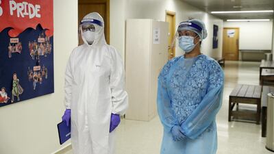 Nurses wear full personal protective equipment while seeing patients.