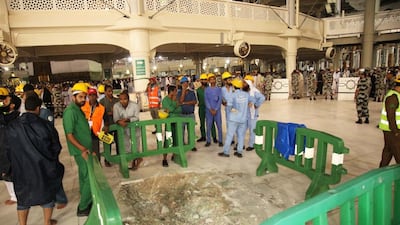 Saudi emergency teams gather at the site of accident in the Grand Mosque of Saudi Arabia’s holy Muslim city of Mecca on September 12, 2015, after a construction crane crashed into it. A massive construction crane crashed into Mecca’s Grand Mosque in stormy weather on, killing at least 107 people and injuring 238, Saudi authorities said, days before the annual Haj pilgrimage. AFP photo
