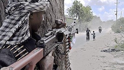 A pro-government militant mans a checkpoint in Mogadishu on Saturday.