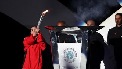 An athlete lights the Olympics torch during the Opening Ceremony on Saturday night. Chris Whiteoak / The National