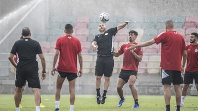 Algeria coach Djamel Belmadi, centre, chests the ball. AFP