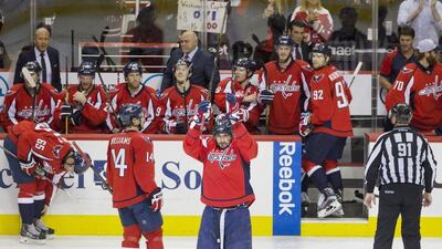 Washington Capitals' Alex Ovechkin, centre, of Russia, acknowledges the fans in celebration as he comes back out of the box to a standing ovation after he scored his 500th career NHL goal during the second period of a hockey game against the Ottawa Senators in Washington, D.C., Sunday, Jan. 10, 2016. (AP Photo/Jacquelyn Martin)