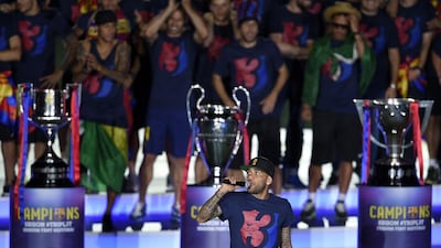 Barcelona’s Brazilian defender Dani Alves delivers a speech as he takes part in the celebrations held for their victory over Juventus, one day after the UEFA Champions League final football, at the Camp Nou stadium in Barcelona on June 7, 2015. Luis Suarez and Neymar scored second-half goals to give Barcelona a 3-1 Champions League final victory over Juventus on June 6, 2015 as the Spaniards became the first team to twice win the European treble. AFP PHOTO/ LLUIS GENE