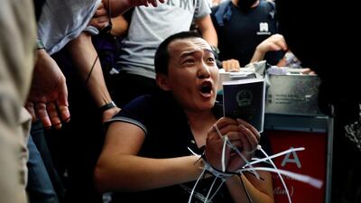 Fu Guohao, a reporter with Chinese media Global Times website, is tied up by protesters during a mass demonstration at the Hong Kong international airport. Reuters