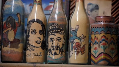 Artwork bearing the likeness of late Palestinian leader Yasser Arafat is displayed in Al-Awawda's souvenir shop. Reuters