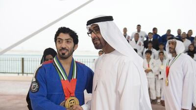 Sheikh Mohammed bin Zayed, Crown Prince of Abu Dhabi and Deputy Supreme Commander of the Armed Forces, congratulates a Jiu-Jitsu World Championship winner after a Sea Palace barza. Rashed Al Mansoori / Crown Prince Court - Abu Dhabi