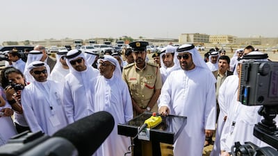 Ahmed Bin Fahad, Minister of Environment and Water (R) and other representatives of various government agencies. pressing the ceremonial ivory crushing machine. Sacks of illegal ivory tusks and ivory figurines and other ivory will be destroyed. Victor Besa for The National.