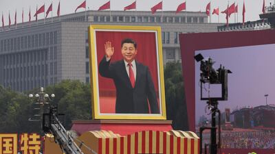 A float with a giant portrait of Chinese President Xi Jinping passes by Tiananmen Square. AFP