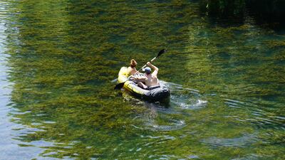A couple row down the Colorado river in Austin.