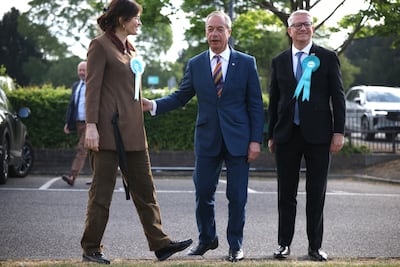 Nigel Farage with Reform UK MP Andrew Rosindell and Laila Cunningham. Dan Kitwood / Getty Images