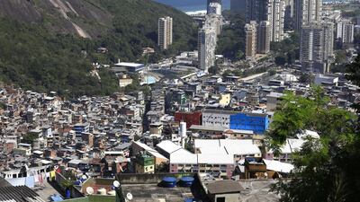The crowded favelas border the wealthier towers and seaside suburbs in Rio de Janeiro. Barbara Walton / EPA