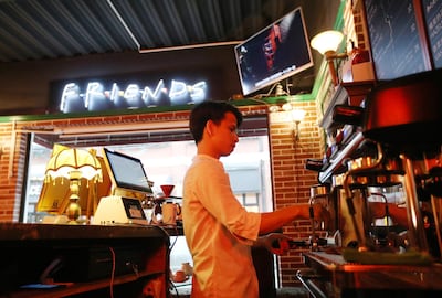 A staff member making coffee at the "Central Perk" coffee shop in Shanghai. AFP
