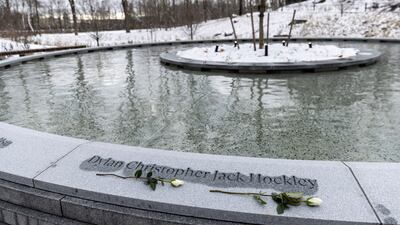 Flowers are placed under the name of one of the victims. AP