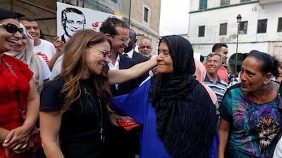 Saloua Samoui, the wife of detained Tunisian media mogul and presidential candidate Nabil Karoui, meets with residents as she distributes election leaflets for Karoui's Heart of Tunisia party. Reuters