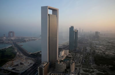 The sun rises over the headquarters of the Abu Dhabi National Oil Company headquarters that dominates the skyline in Abu Dhabi. AP