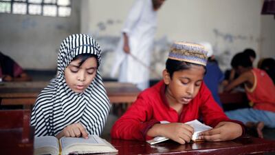 Bangladeshi Muslim children read the holy Koran at the Madrasa in Dhaka. EPA