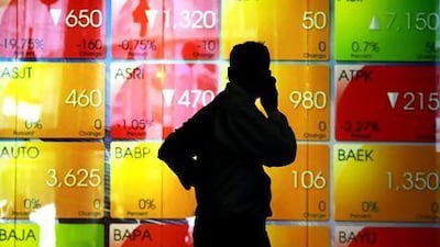 A man walks in front of a stocks board at the stock exchange in Jakarta. The rapidly growing middle class is a prime driver of economic growth in countries such as Indonesia. EPA / MAST IRHAM
