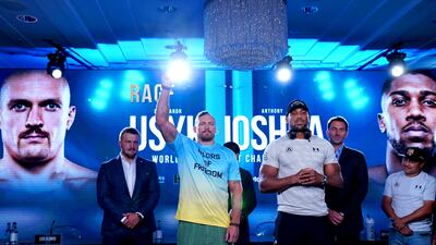 Oleksandr Usyk and Anthony Joshua on stage. PA