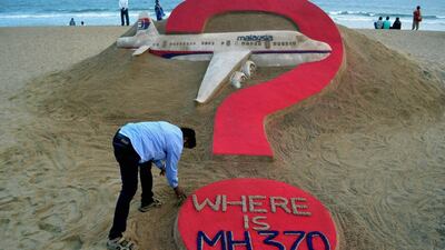 Indian sand artist Sudarsan Pattnaik creating a sand sculpture of the missing Malaysian airliner MH370 on Puri beach in eastern Odisha state. JK Jagdev / AFP