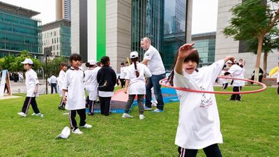 Children and adults enjoyed trying new activities in one of the events for the UAE National Sports Day in Dubai. Victor Besa for The National