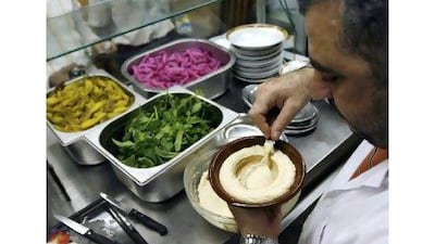 A Lebanese chef prepares a dish of hummus. The country's cuisine is sought after by global consumers.