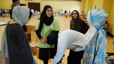 Volunteers with the Islamic Society of Greater Houston package donations at a mosque-turned-shelter. Houston's Muslim community, which numbers about 60,000, has opened many of its community centres and sent hundreds of volunteers to serve food and deliver donations. Some have rescued neighbours from high water. Jay Reeves / AP