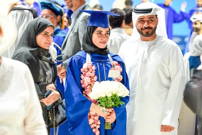 Students from the Mohamed bin Zayed University of Artificial Intelligence in Abu Dhabi celebrate their graduation with family members last year. Pawan Singh for The National